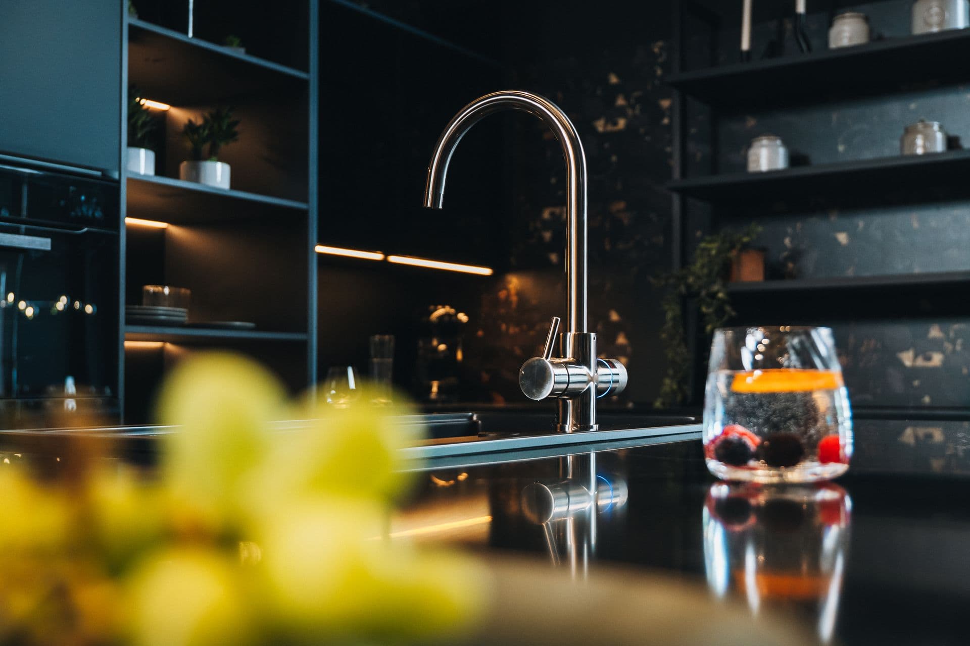 Filtered water being poured from a WELLQ tap into a glass